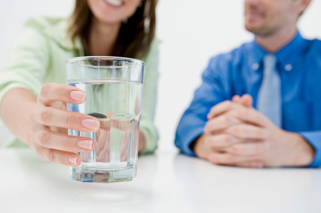 Woman reaching for a water glass